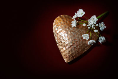 Close-up of heart shape decoration against black background