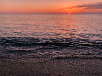 Scenic view of sea against orange sky