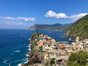 High angle view of townscape by sea against sky. vernazza, italia