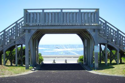 Bridge over road against sky