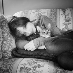 Close-up of woman lying on sofa at home