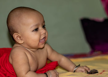 Portrait of cute baby girl on bed