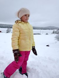 Full length of girl standing in snow