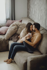 Woman relaxing on sofa at home