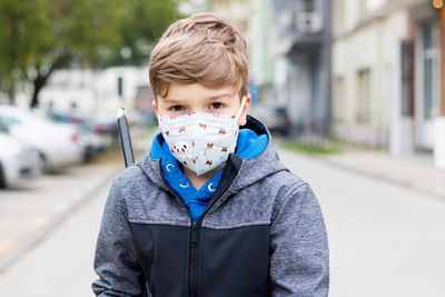 Portrait of boy on street in city