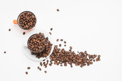 High angle view of coffee beans against white background