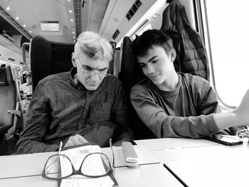 Father and son sitting in train