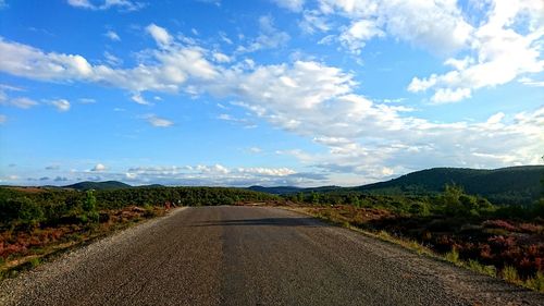 Road amidst landscape against sky