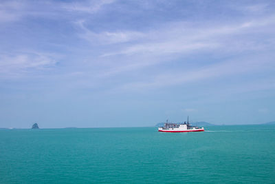 Boat sailing in sea against sky