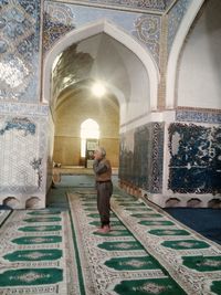 Rear view of man walking in temple