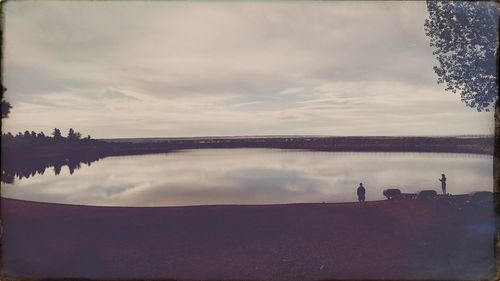 Scenic view of lake against cloudy sky