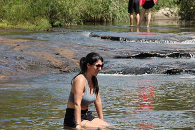 Woman sitting in river
