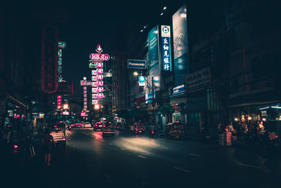 Illuminated city street and buildings at night