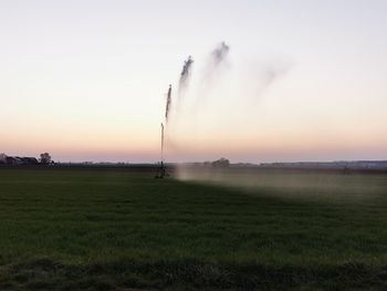 Scenic view of field against sky during sunset