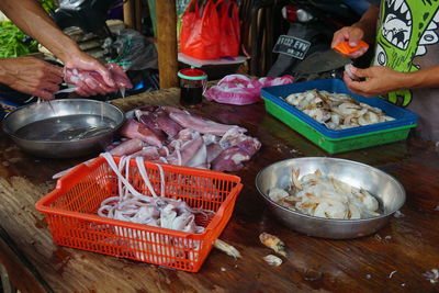 High angle view of man preparing food on table at market