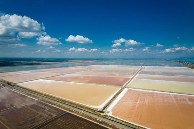 Scenic view of agricultural landscape against blue sky