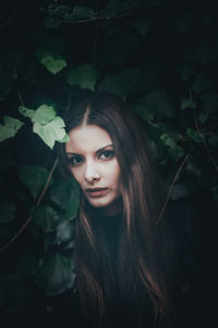 Portrait of young woman with leaves
