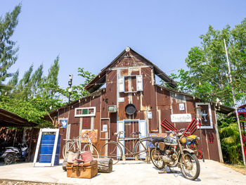 Bicycle by building against sky