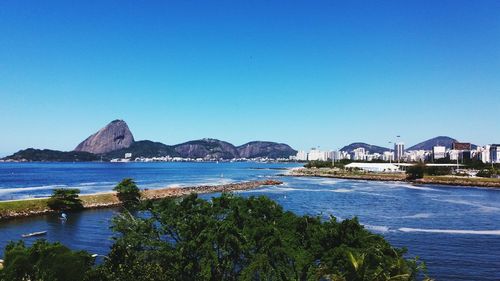 Scenic view of sea against clear blue sky