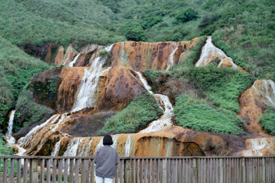 Woman in front of waterfalls on mountain