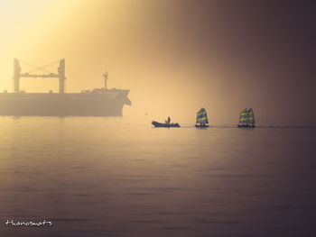 Ship in sea against sky during sunset