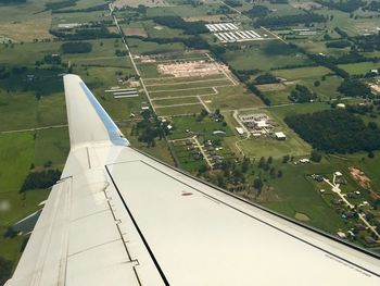 Aerial view of airplane flying above landscape