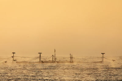 Scenic view of sea against clear sky during sunset