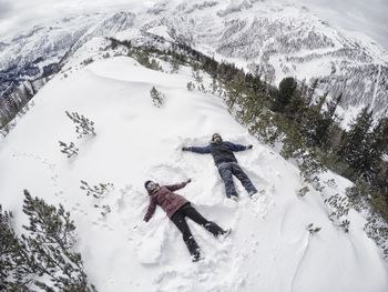 People skiing on snow covered mountain