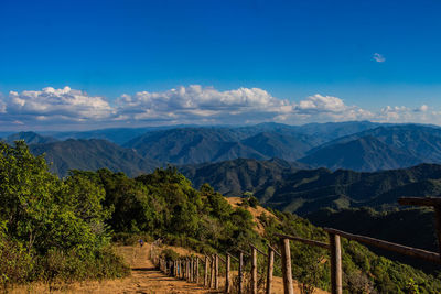 Scenic view of mountains against blue sky