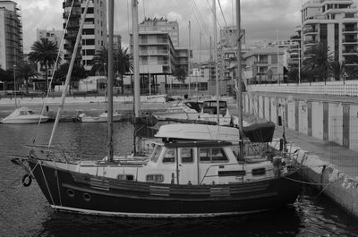 Boats in river with buildings in background