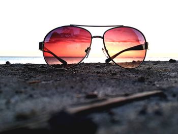 Close-up of sunglasses against clear sky