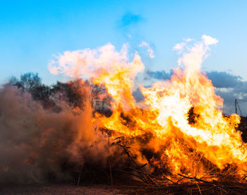 Close-up of bonfire against sky