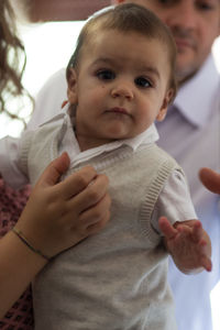 Close-up portrait of baby boy with mother