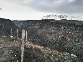 Scenic view of mountains against cloudy sky