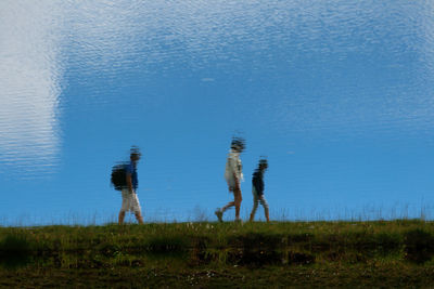 Reflection of people on river