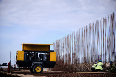 Cars on field against sky