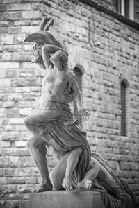 Low angle view of statue against building 