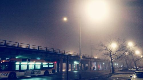 Illuminated city against sky at night