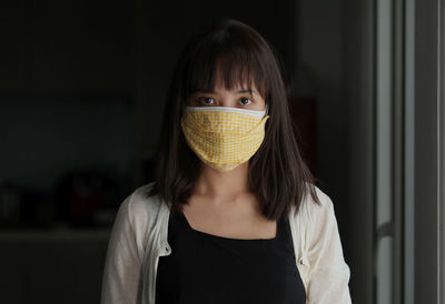 Portrait of an attractive healthy girl, wearing a reusable cotton mask