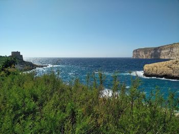 Scenic view of sea against clear blue sky