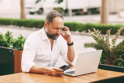 Businessman using laptop at table