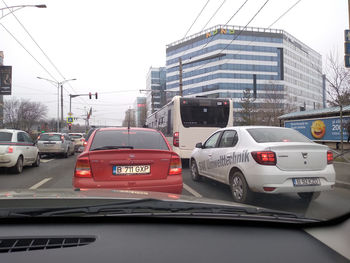 Cars on street against buildings in city