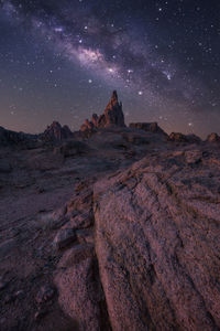 Rock formations against sky at night