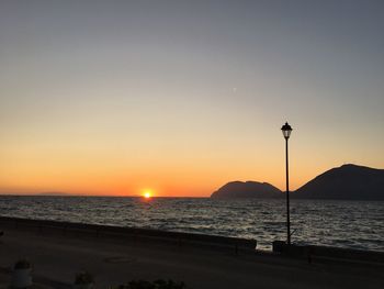 Scenic view of sea against clear sky during sunset