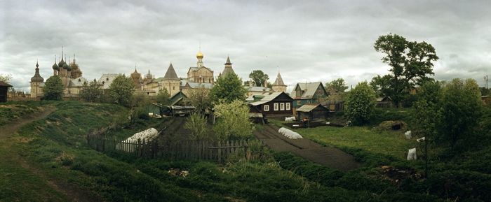 Panoramic view of trees and buildings against sky