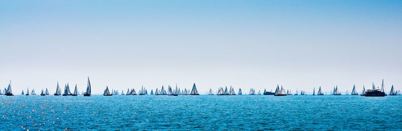 Sailboats on sea against sky