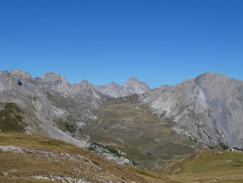 Panoramic alpine landscape against clear blue sky near colle del preit