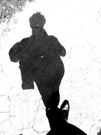 Low section of person standing on shadow