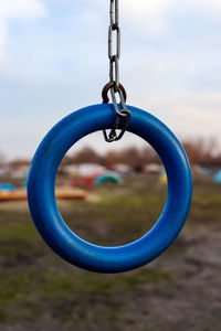 Close-up of swing hanging in playground