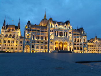 Illuminated government building in city at dusk